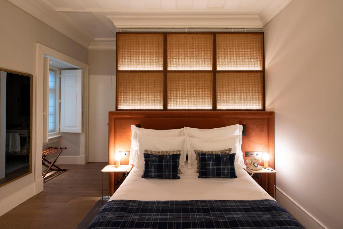 Uma cama ou camas num quarto em Palácio Ludovice Wine Experience Hotel