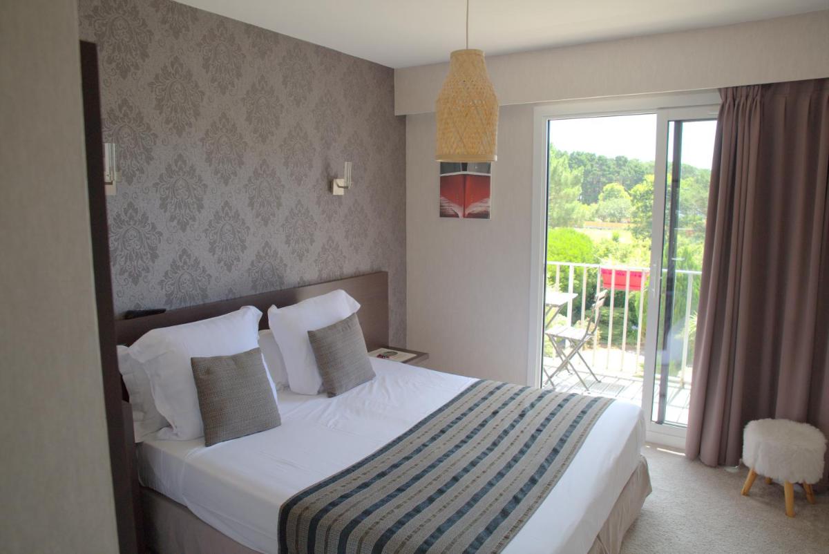 Un ou plusieurs lits dans un hébergement de l'établissement Le Galet Hotel & Spa