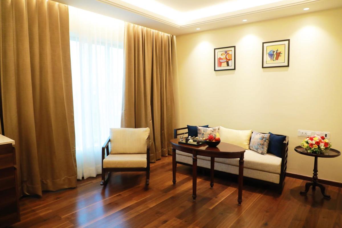 a living room with a couch and a table at Taj Tirupati in Tirupati