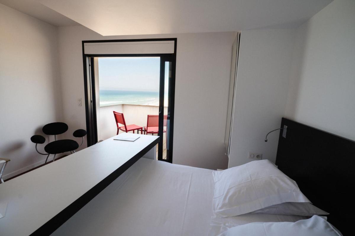 Un ou plusieurs lits dans un hébergement de l'établissement Le Grand Hotel de la Plage