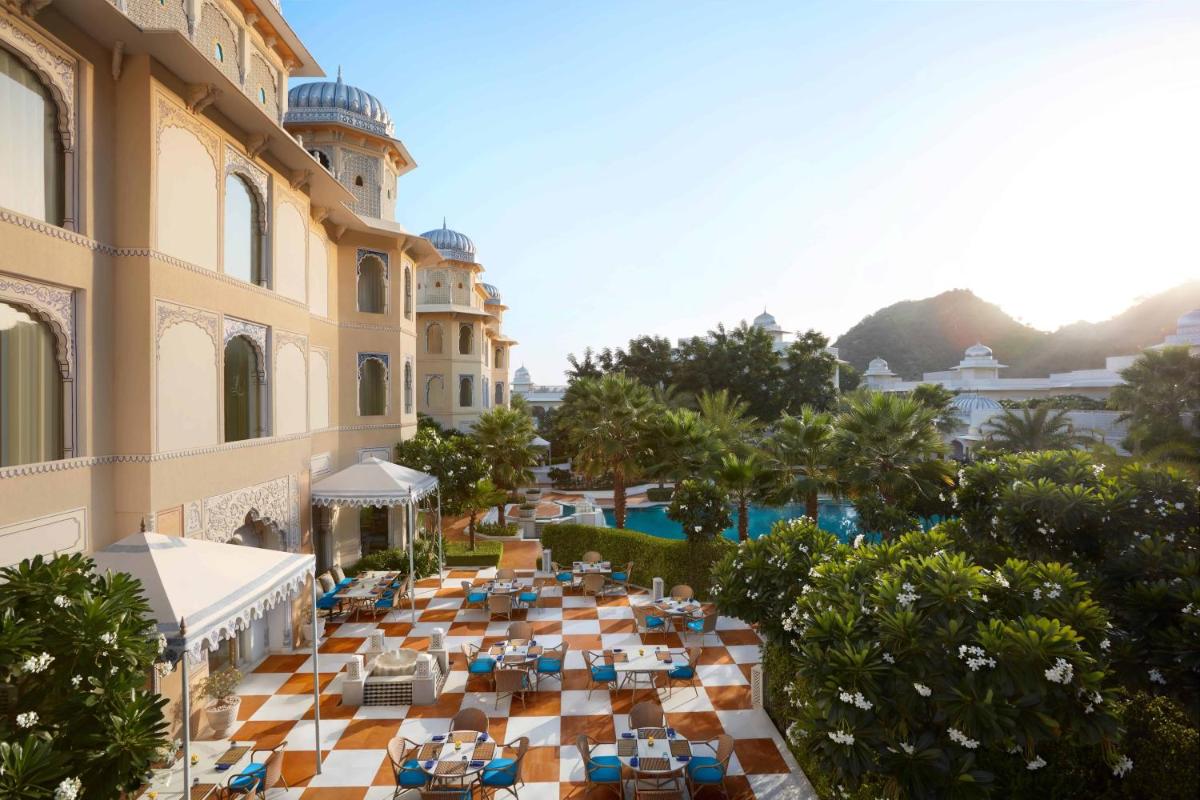 an overhead view of a resort with a pool and tables and chairs at The Leela Palace Jaipur in Jaipur