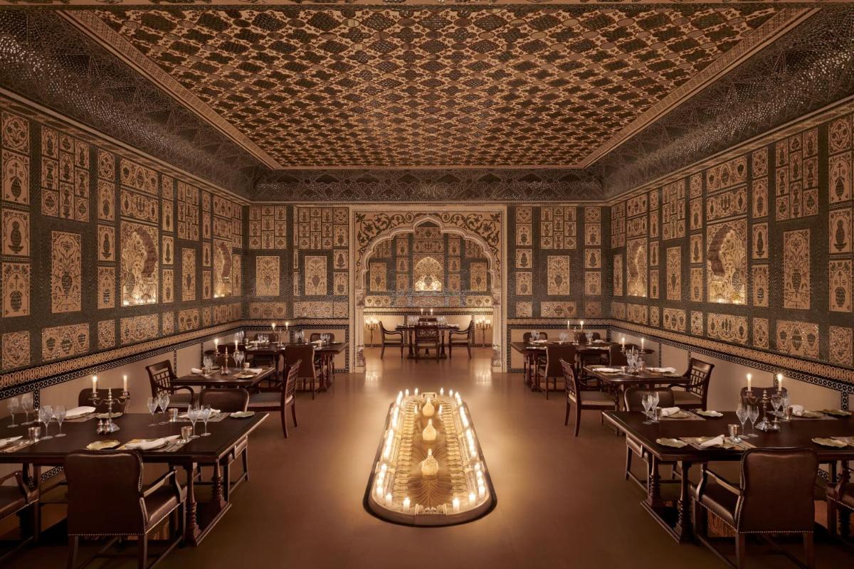 an image of a dining room with tables and chairs at The Leela Palace Jaipur in Jaipur