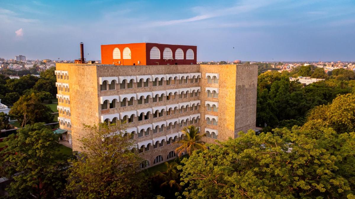 a tall brick building with an orange roof at Taj Ganges Varanasi in Varanasi