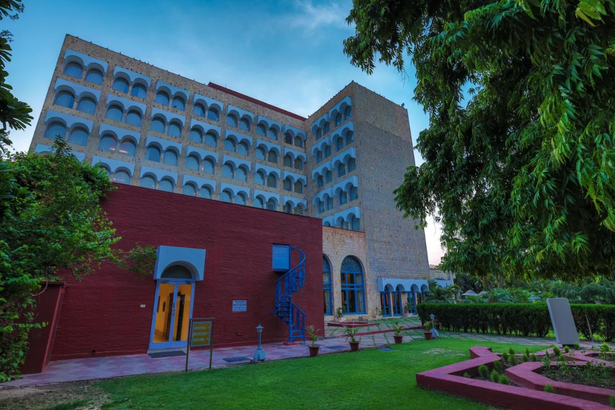 a large building with a red brick building at Taj Ganges Varanasi in Varanasi