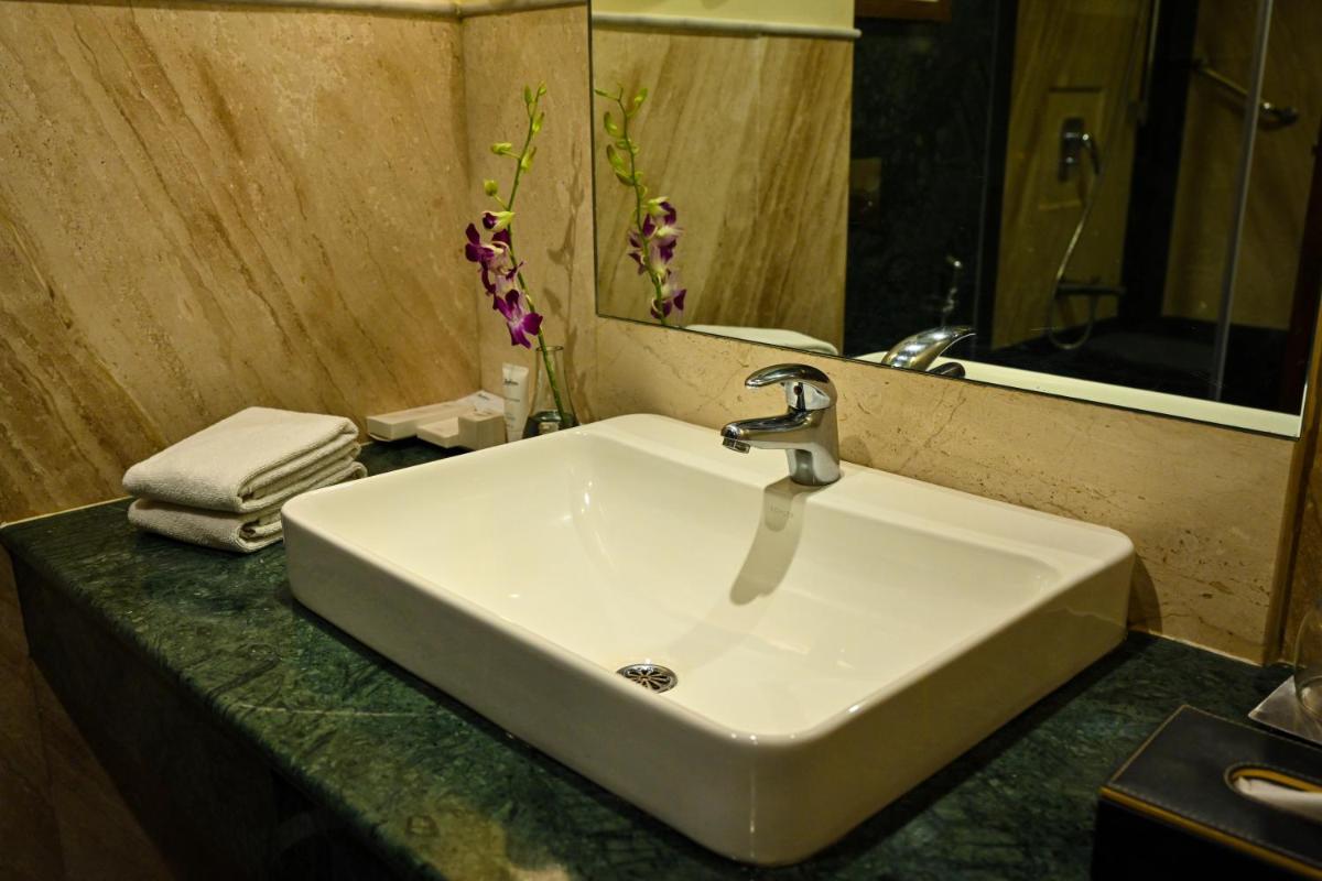 a white sink in a bathroom with a mirror at Radisson Jodhpur in Jodhpur