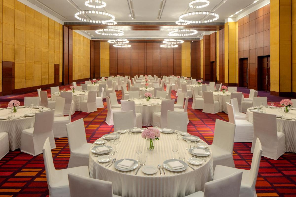 a large banquet hall with white tables and white chairs at Hyatt Regency Chandigarh in Chandīgarh