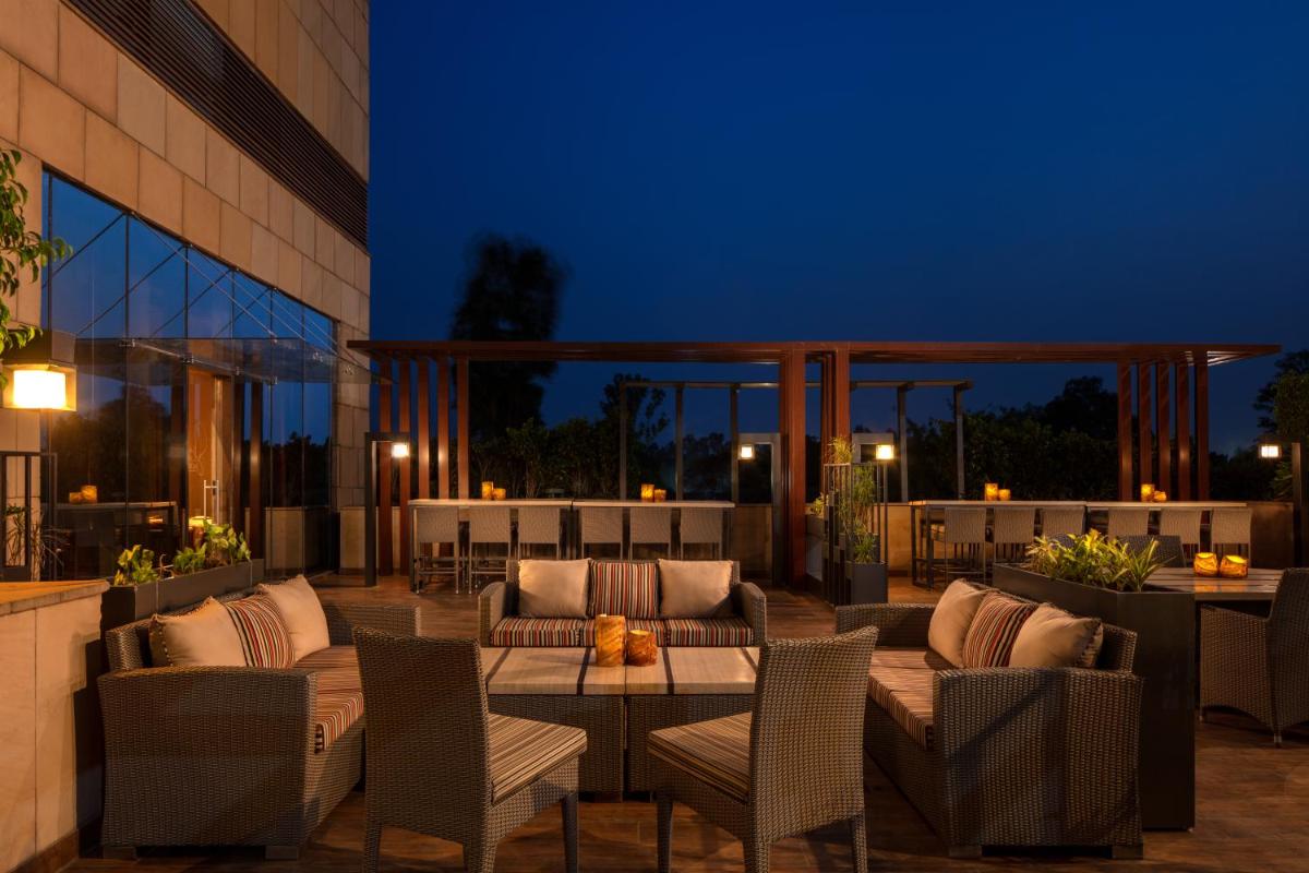 a patio with chairs and a table at night at Hyatt Regency Chandigarh in Chandīgarh