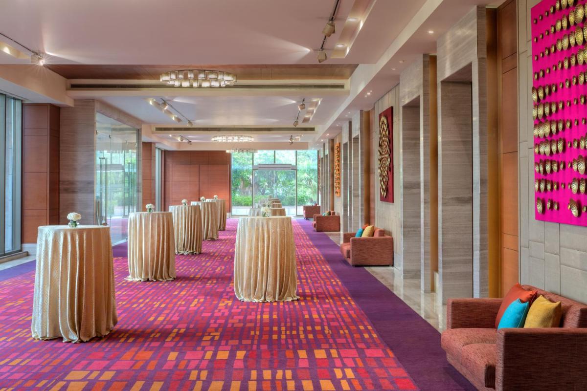 a row of tables in a hallway with chairs at Hyatt Regency Chandigarh in Chandīgarh