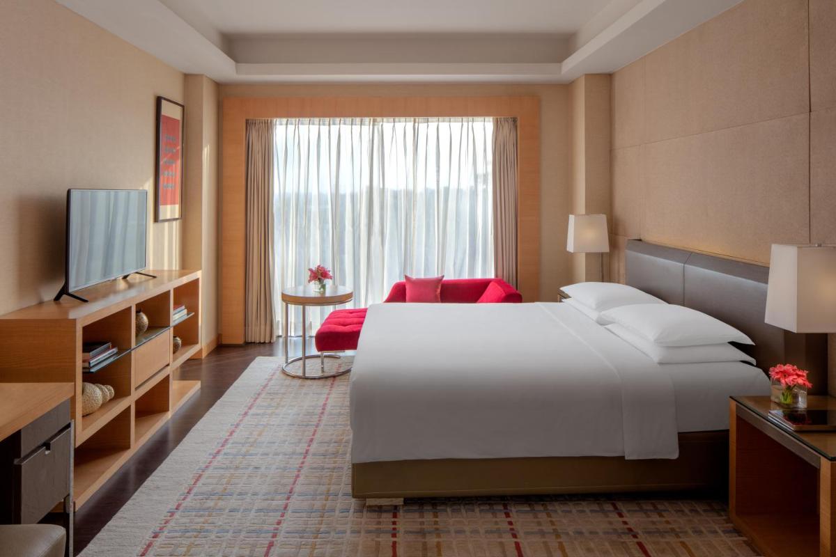 a bedroom with a large white bed and a window at Hyatt Regency Chandigarh in Chandīgarh
