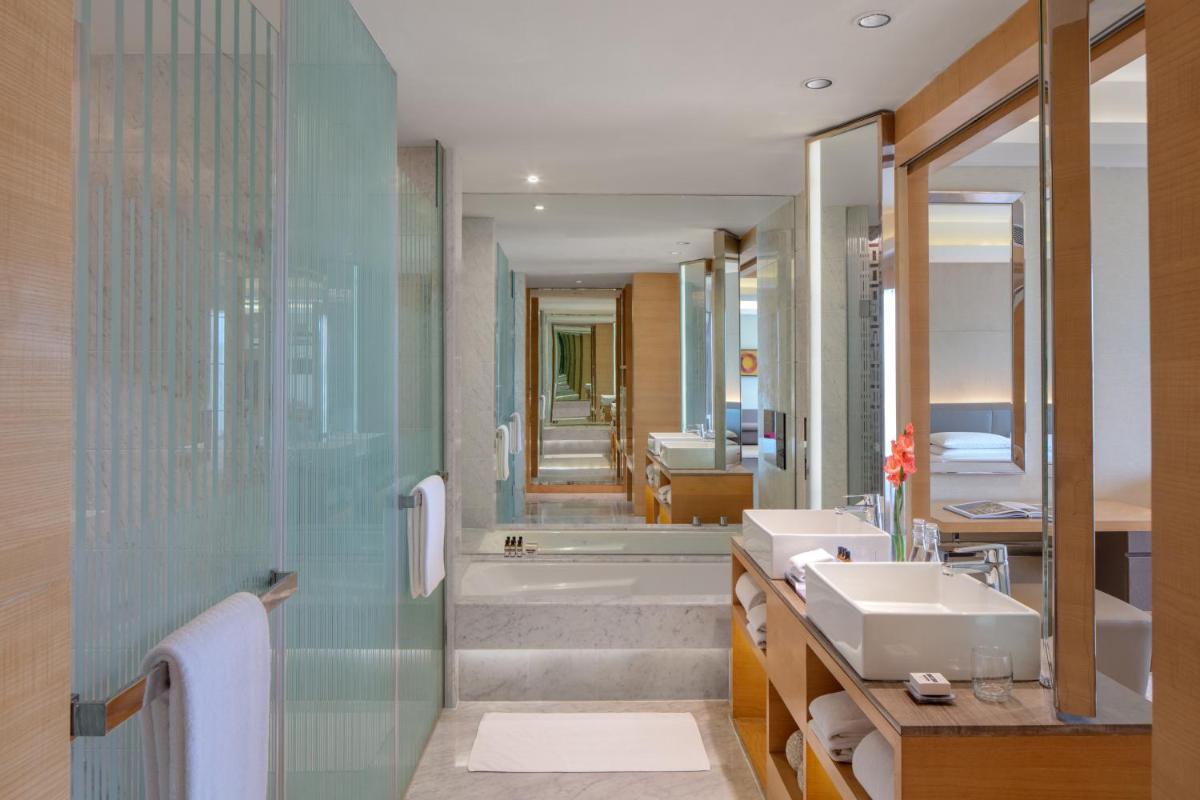 a bathroom with a sink and a shower and a tub at Hyatt Regency Chandigarh in Chandīgarh