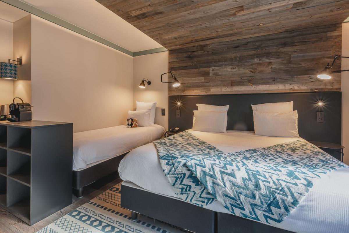 Un ou plusieurs lits dans un hébergement de l'établissement Chalet Hôtel Le Prieuré & Spa