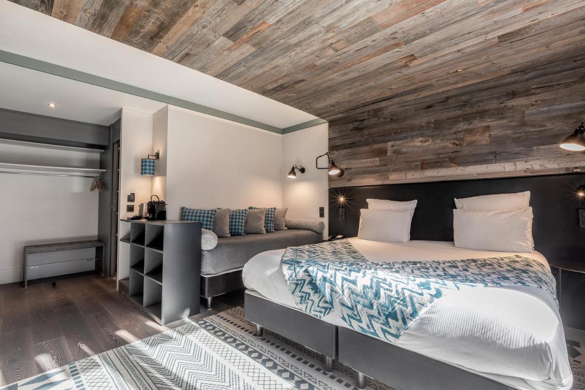 Un ou plusieurs lits dans un hébergement de l'établissement Chalet Hôtel Le Prieuré & Spa