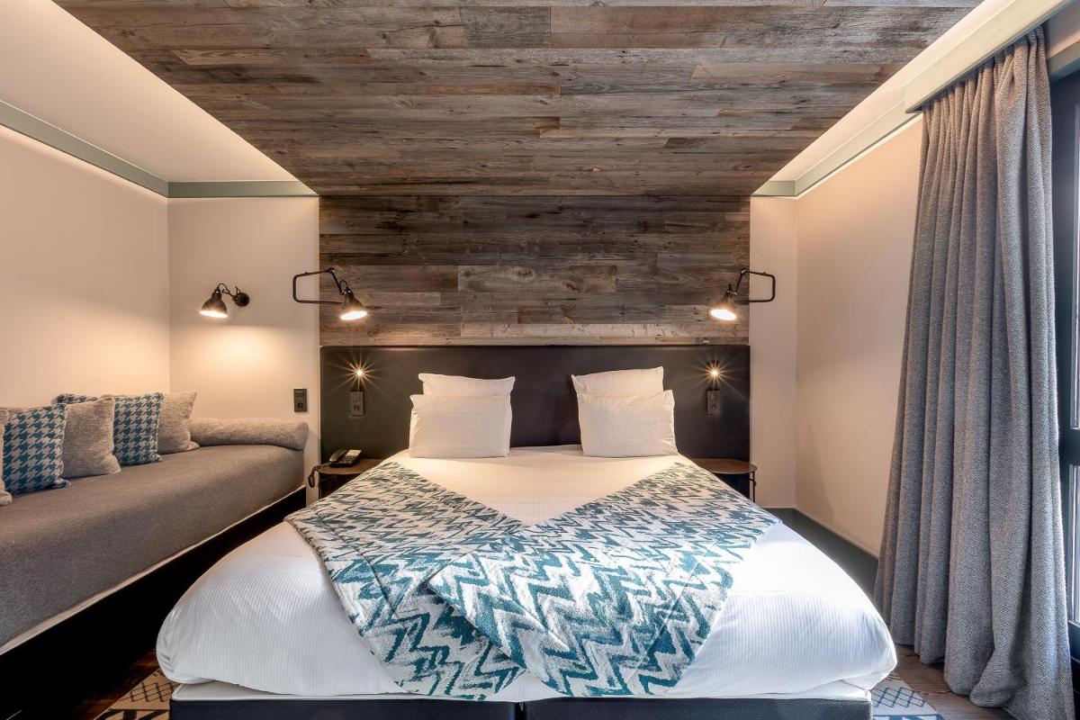 Un ou plusieurs lits dans un hébergement de l'établissement Chalet Hôtel Le Prieuré & Spa