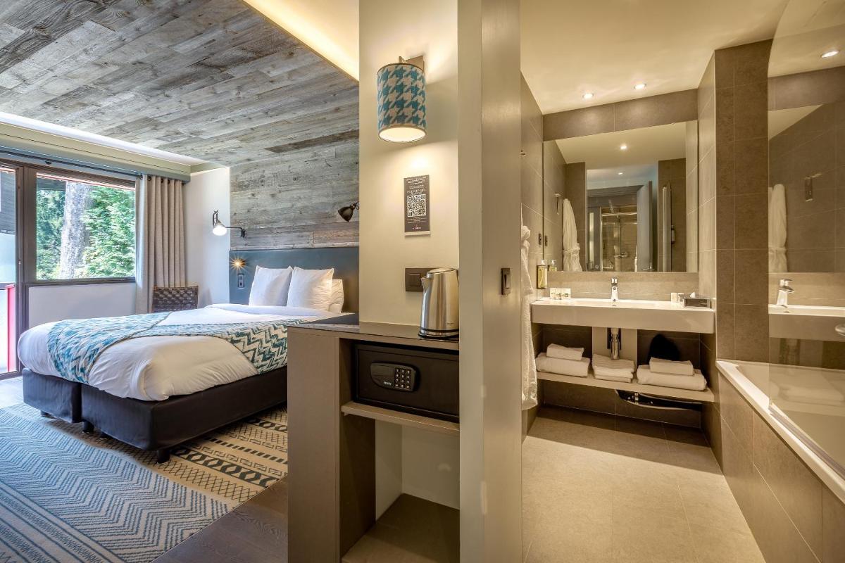 Un ou plusieurs lits dans un hébergement de l'établissement Chalet Hôtel Le Prieuré & Spa