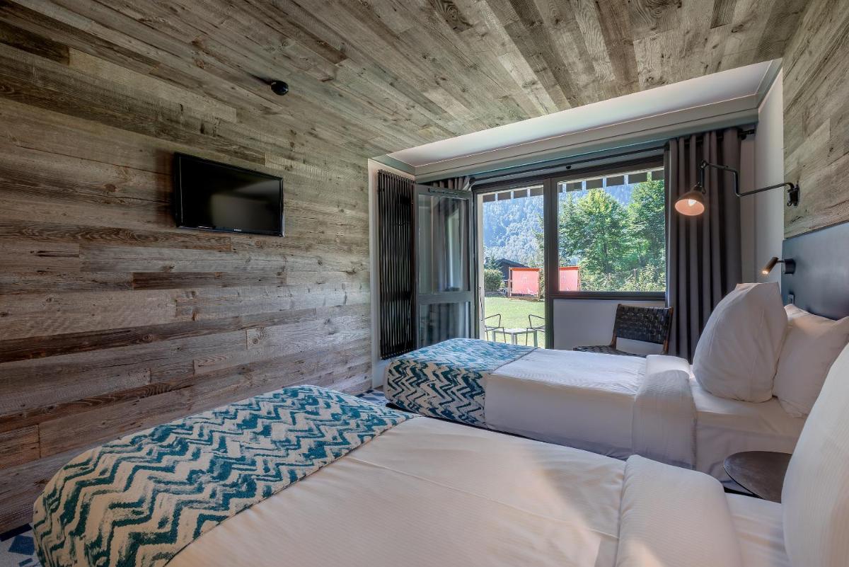 Un ou plusieurs lits dans un hébergement de l'établissement Chalet Hôtel Le Prieuré & Spa