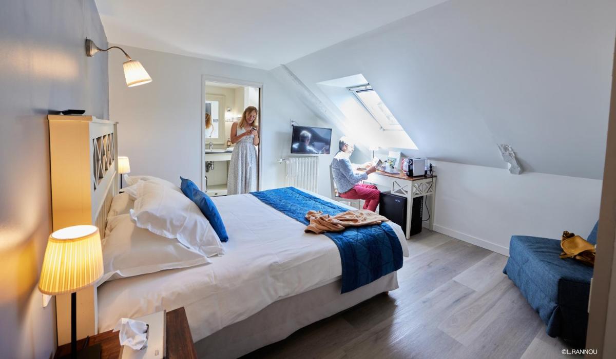 Un ou plusieurs lits dans un hébergement de l'établissement Logis Hotel, restaurant et spa Le Relais De Broceliande