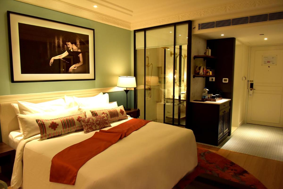 a bedroom with a large bed and a painting on the wall at Radisson Hotel Shimla in Shimla