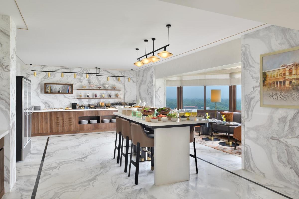 a kitchen and living room with a large marble wall at Taj Mahal, New Delhi in New Delhi
