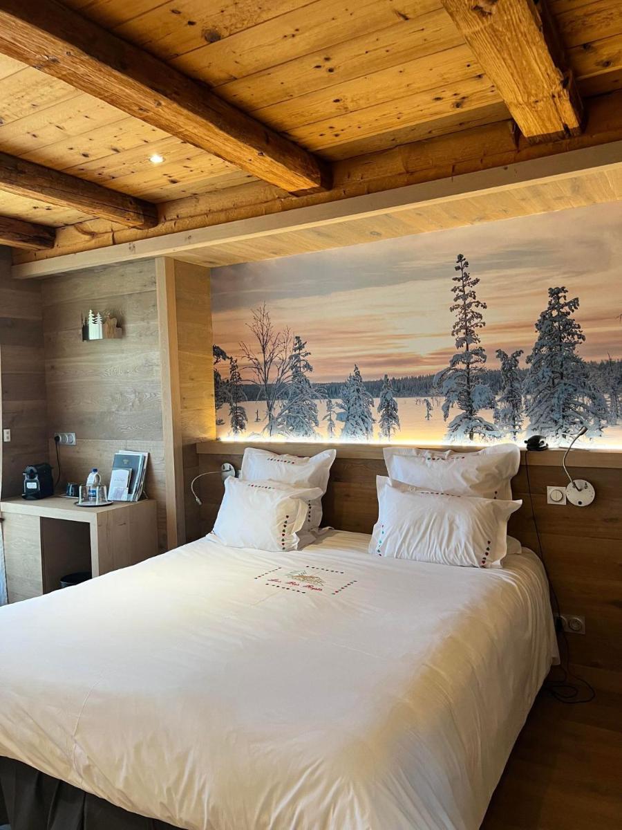 - une chambre avec un grand lit blanc orné d'une peinture murale dans l'établissement Hôtel-Restaurant Les Bas-Rupts, Singuliers Hôtel, à Gérardmer 67 autres photos