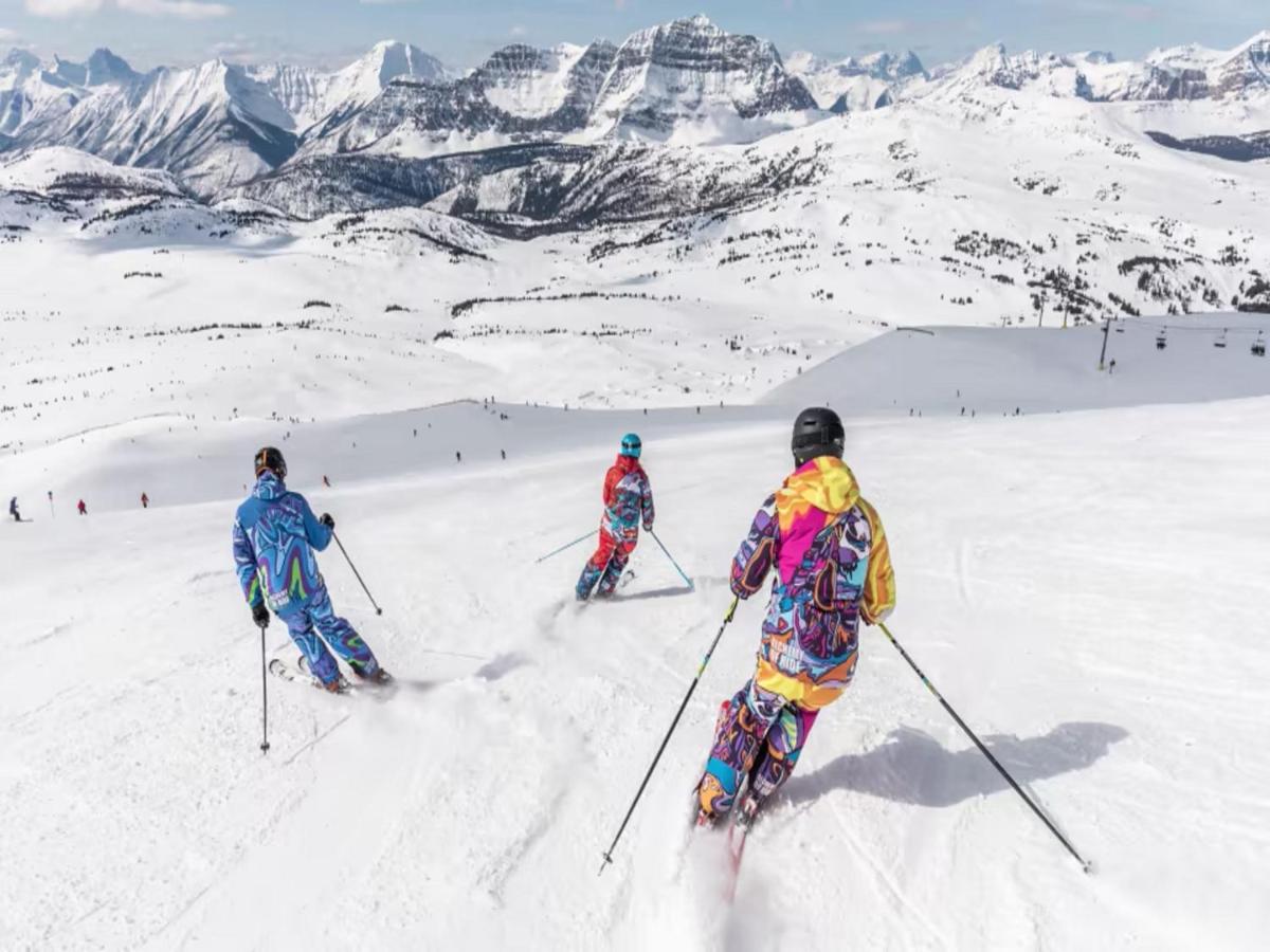three people are skiing down a snow covered mountain at The Orchid Shimla in Shimla