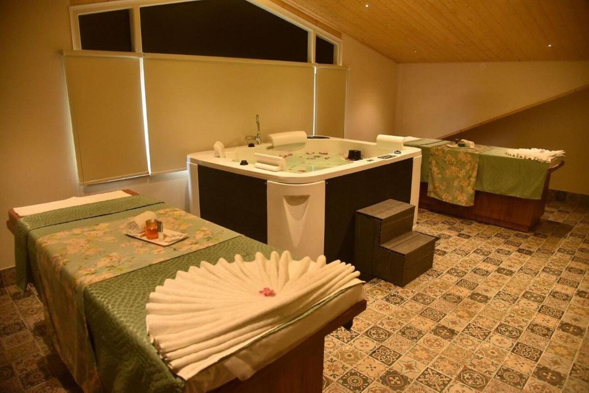a bathroom with a tub and a sink at The Orchid Shimla in Shimla