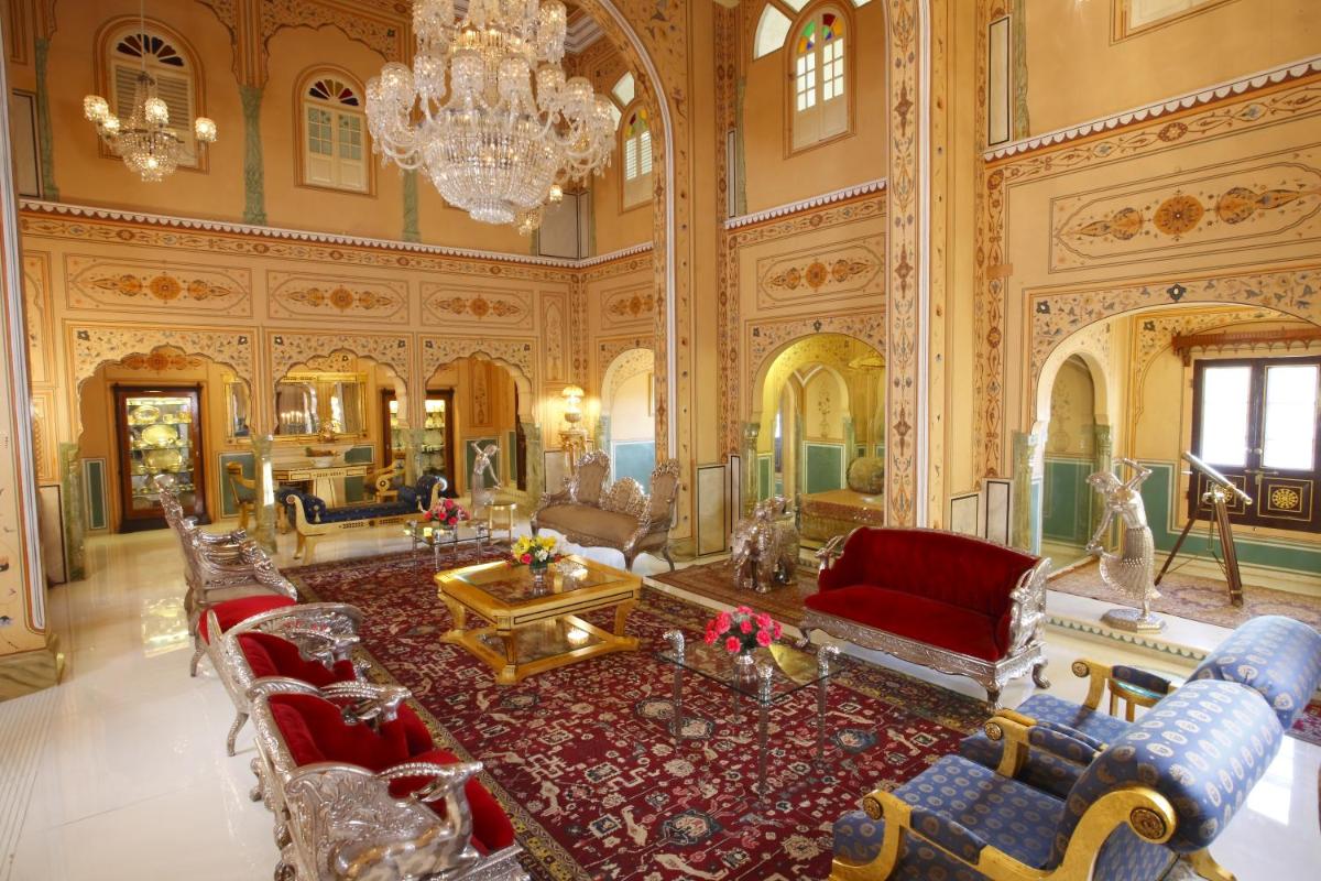 a large living room with a chandelier at The Raj Palace (Small Luxury Hotels of the World) in Jaipur