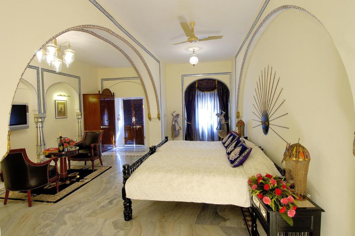 a bedroom with a large bed in a room at The Raj Palace (Small Luxury Hotels of the World) in Jaipur