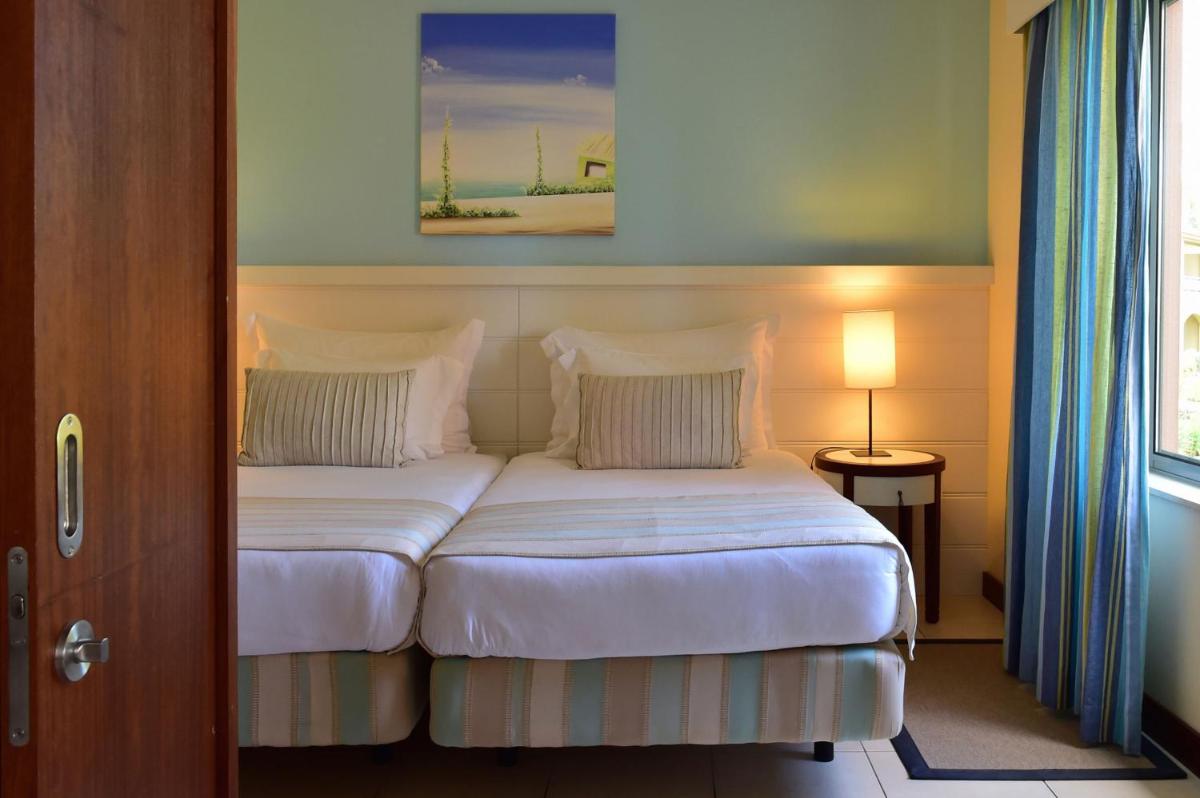 Uma cama ou camas num quarto em Pestana Porto Santo Premium All Inclusive Beach & SPA Resort