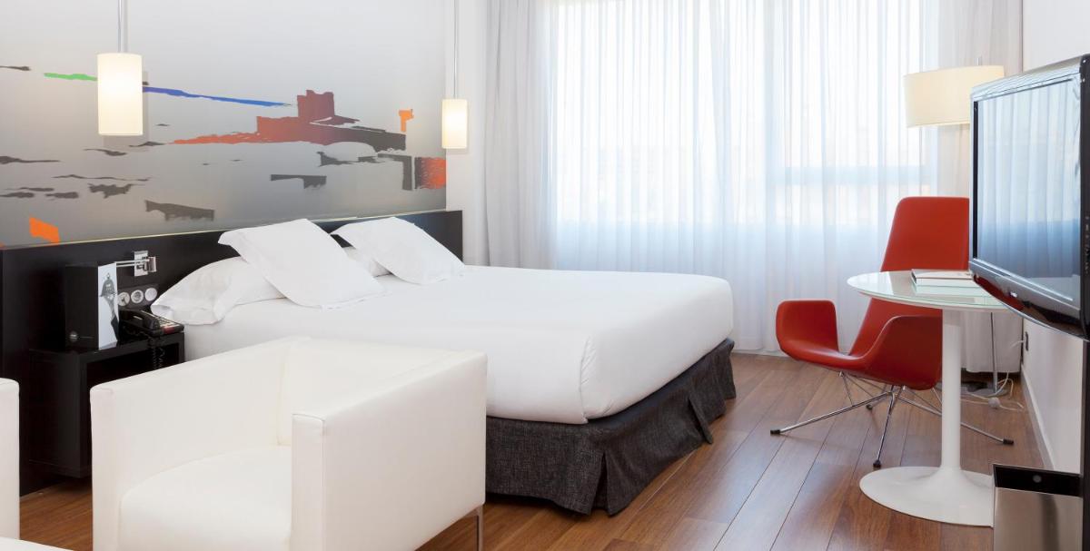 Cama o camas de una habitación en Axor Barajas