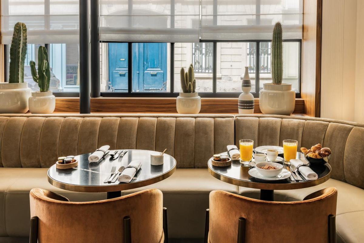deux tables avec de la nourriture et des boissons sur un canapé dans l'établissement Pavillon Faubourg Saint-Germain & Spa, à Paris