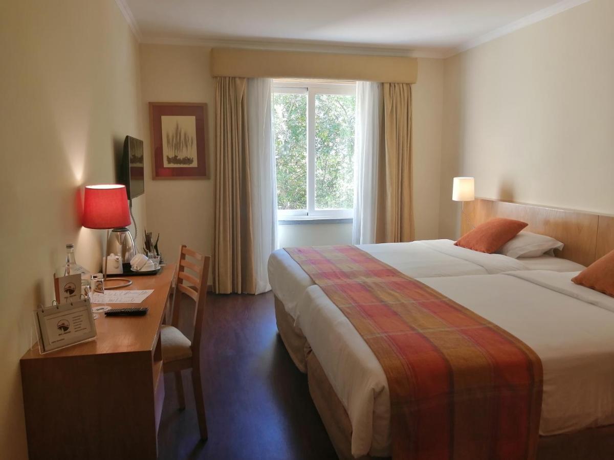 Uma cama ou camas num quarto em Hotel Da Montanha