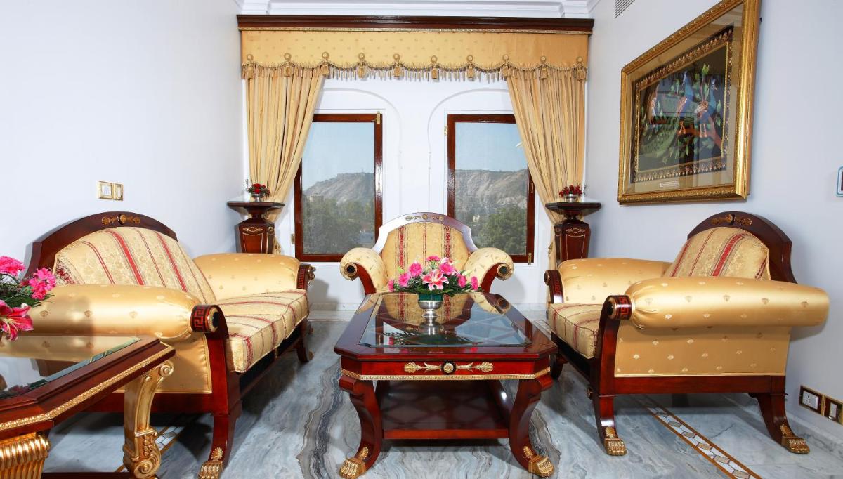 a living room with two couches and a table at The Raj Palace (Small Luxury Hotels of the World) in Jaipur