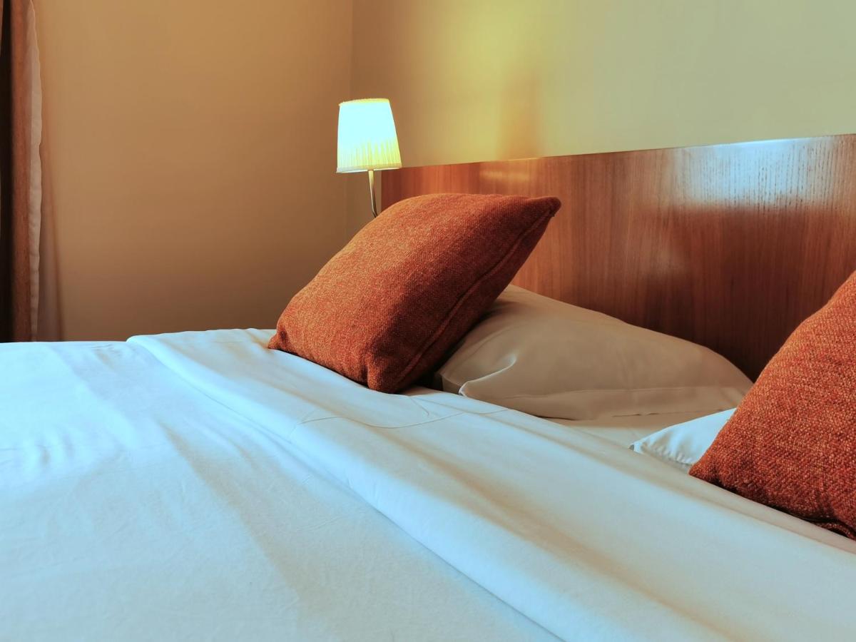 Uma cama ou camas num quarto em Hotel Da Montanha
