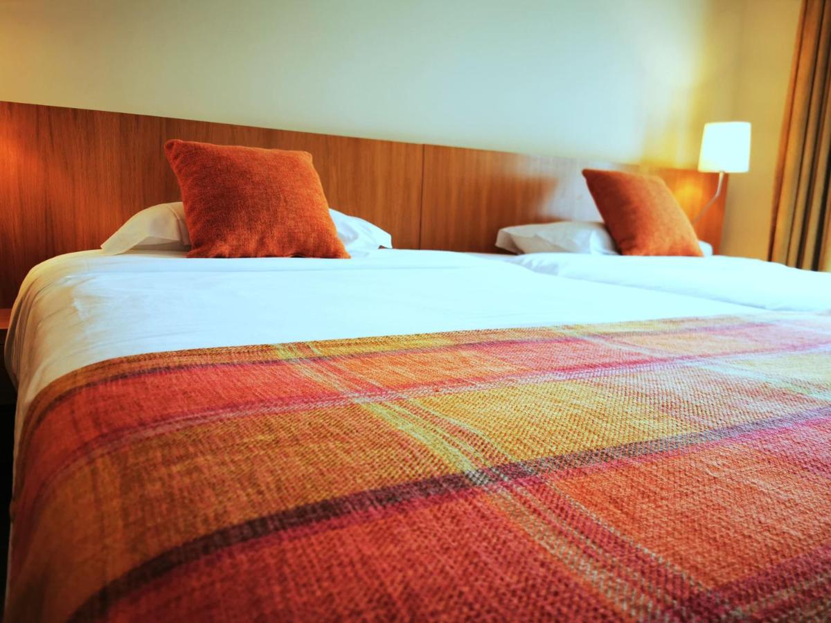 Uma cama ou camas num quarto em Hotel Da Montanha