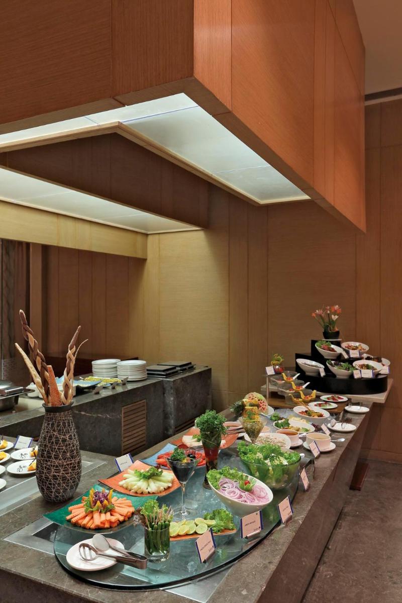 a buffet line with many plates of food on it at Yashail Hotel Haridwar in Haridwār