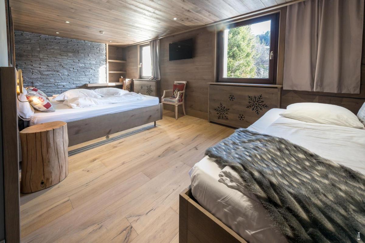 Un ou plusieurs lits dans un hébergement de l'établissement Chalet Hôtel & Spa Le Collet