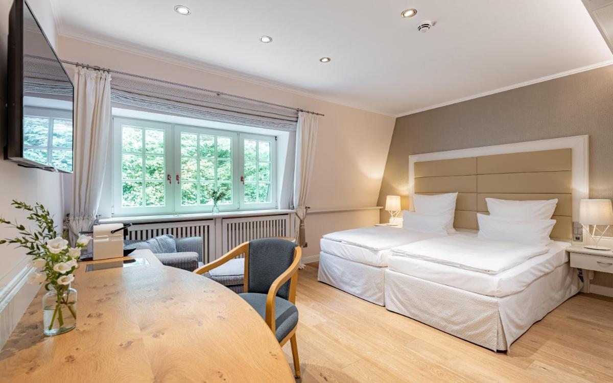 Ein Bett oder Betten in einem Zimmer der Unterkunft Waldhaus Reinbek