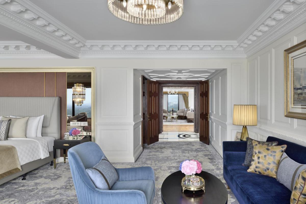 a bedroom with a bed and a living room at Taj Mahal, New Delhi in New Delhi