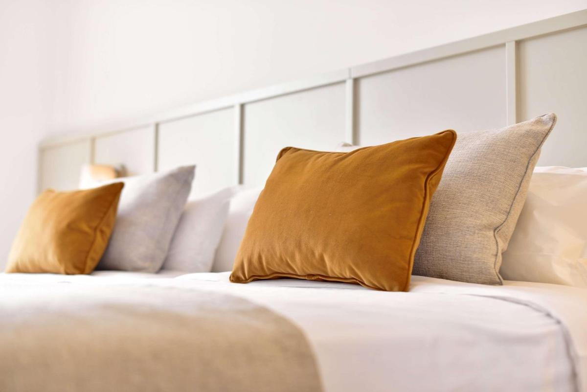 Uma cama ou camas num quarto em Dolce CampoReal Lisboa