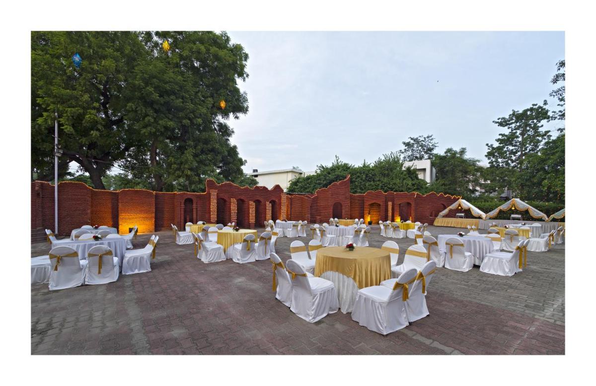 a group of tables and chairs in a courtyard at Clarks Avadh in Lucknow