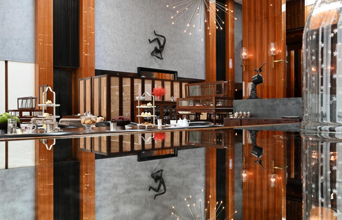 a dining room with a table and a bar at Grand Hyatt Gurgaon in Gurgaon