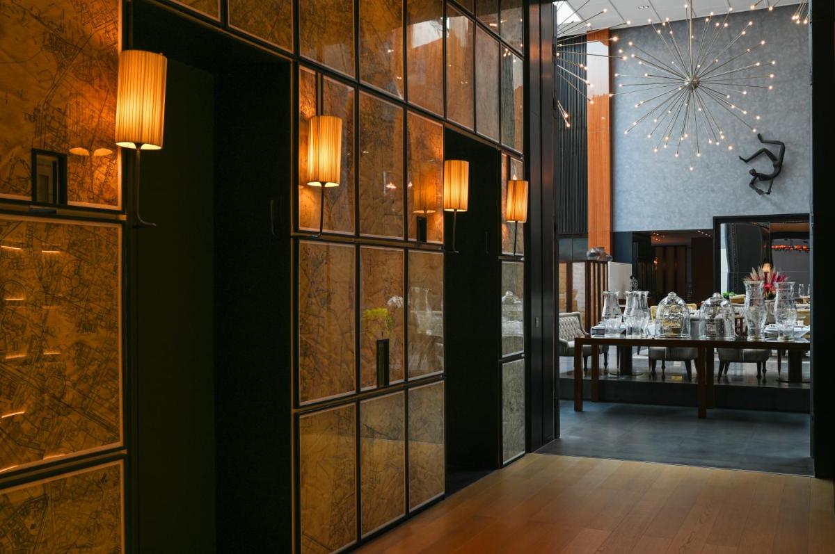 a restaurant with a dining room with tables at Grand Hyatt Gurgaon in Gurgaon