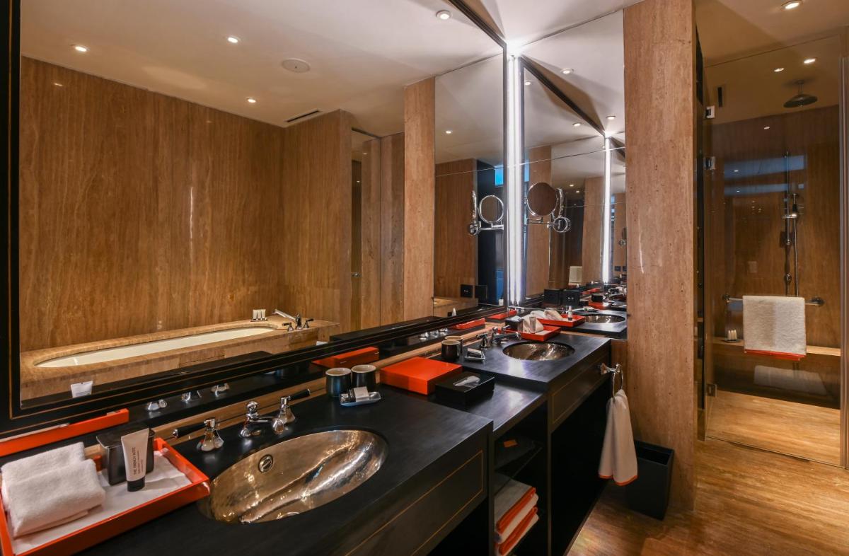 a bathroom with two sinks and a large mirror at Grand Hyatt Gurgaon in Gurgaon