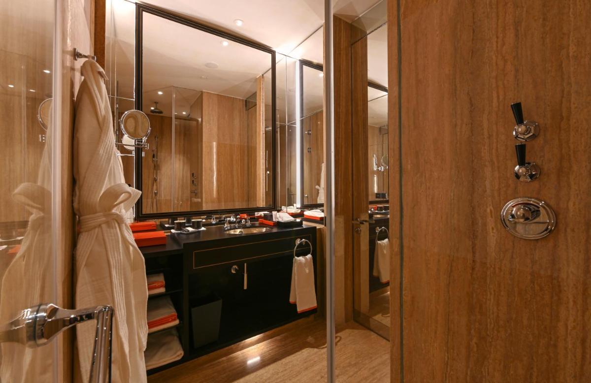 a bathroom with a sink and a shower with a mirror at Grand Hyatt Gurgaon in Gurgaon