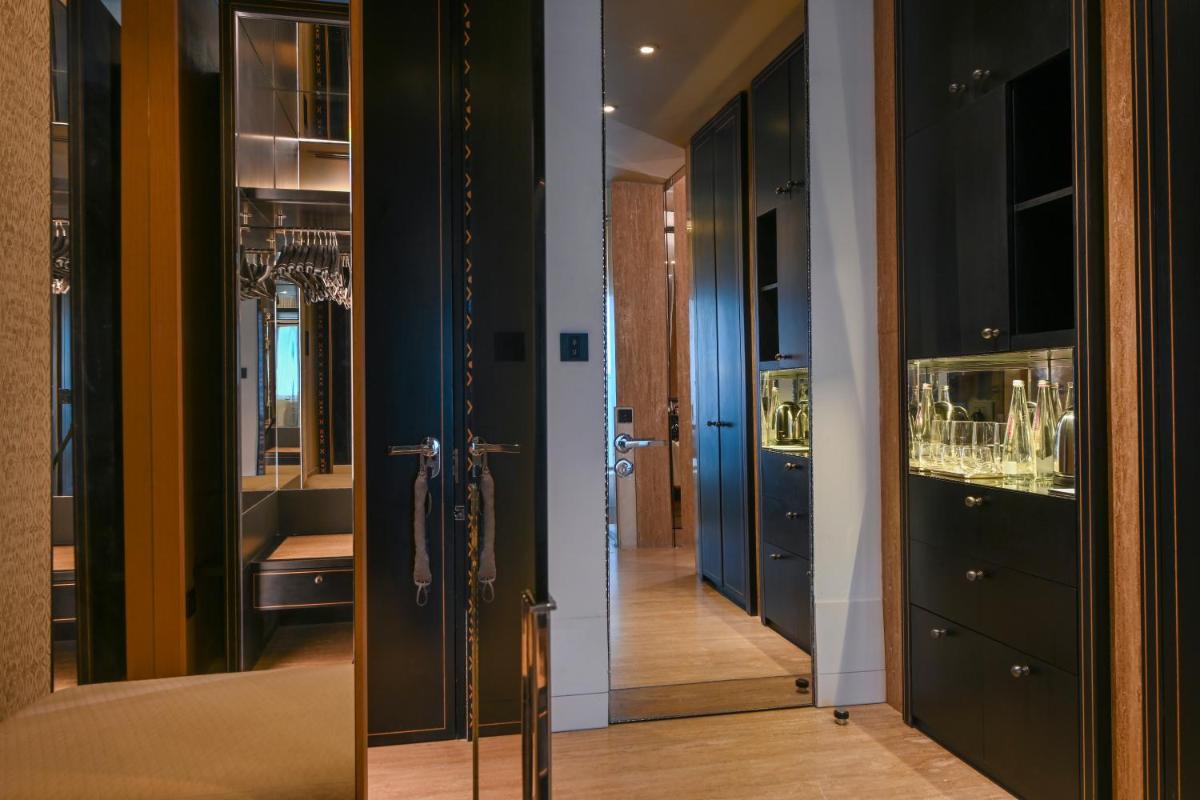 a hallway with a glass door and a mirror at Grand Hyatt Gurgaon in Gurgaon
