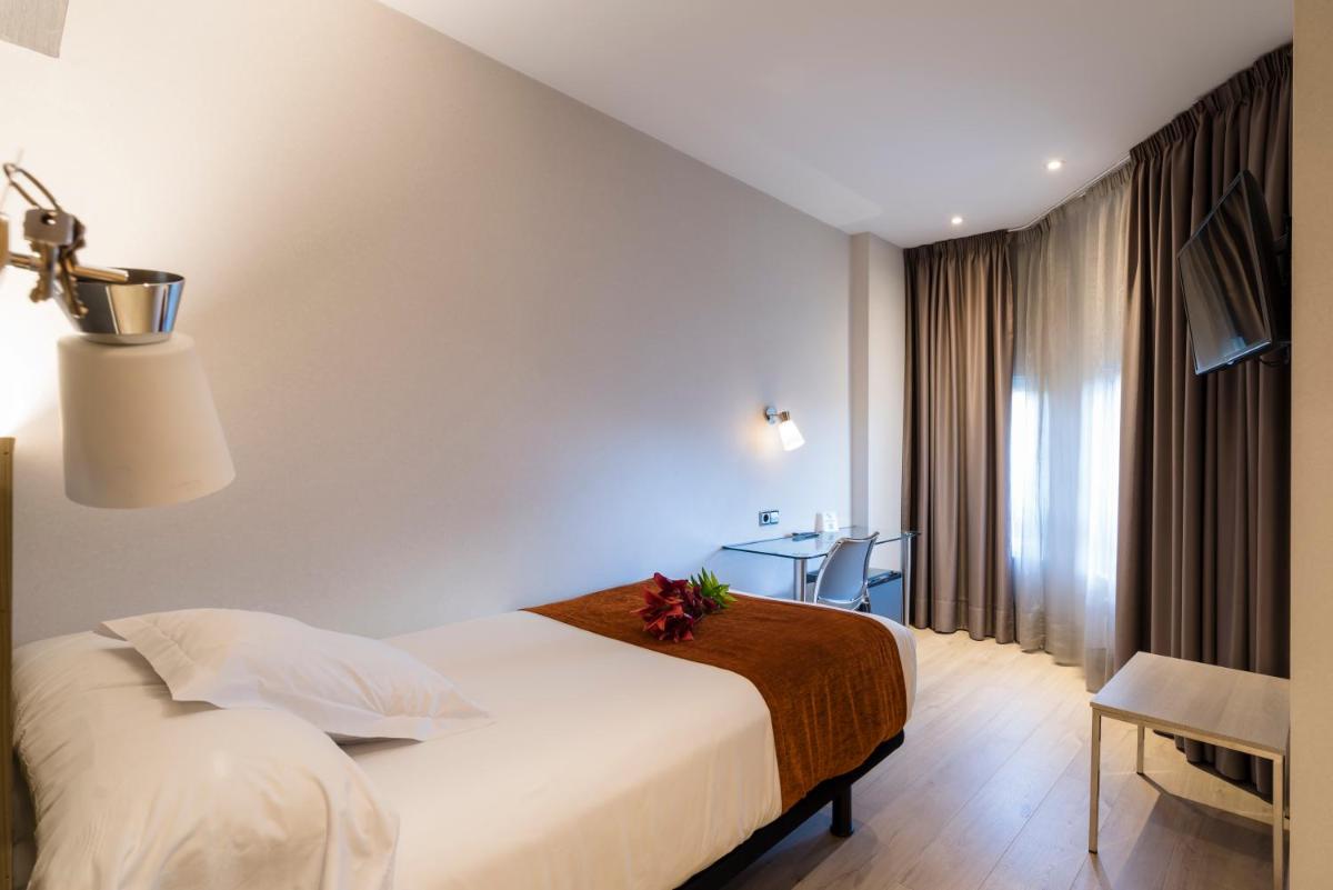 Cama o camas de una habitación en Hotel Avenida