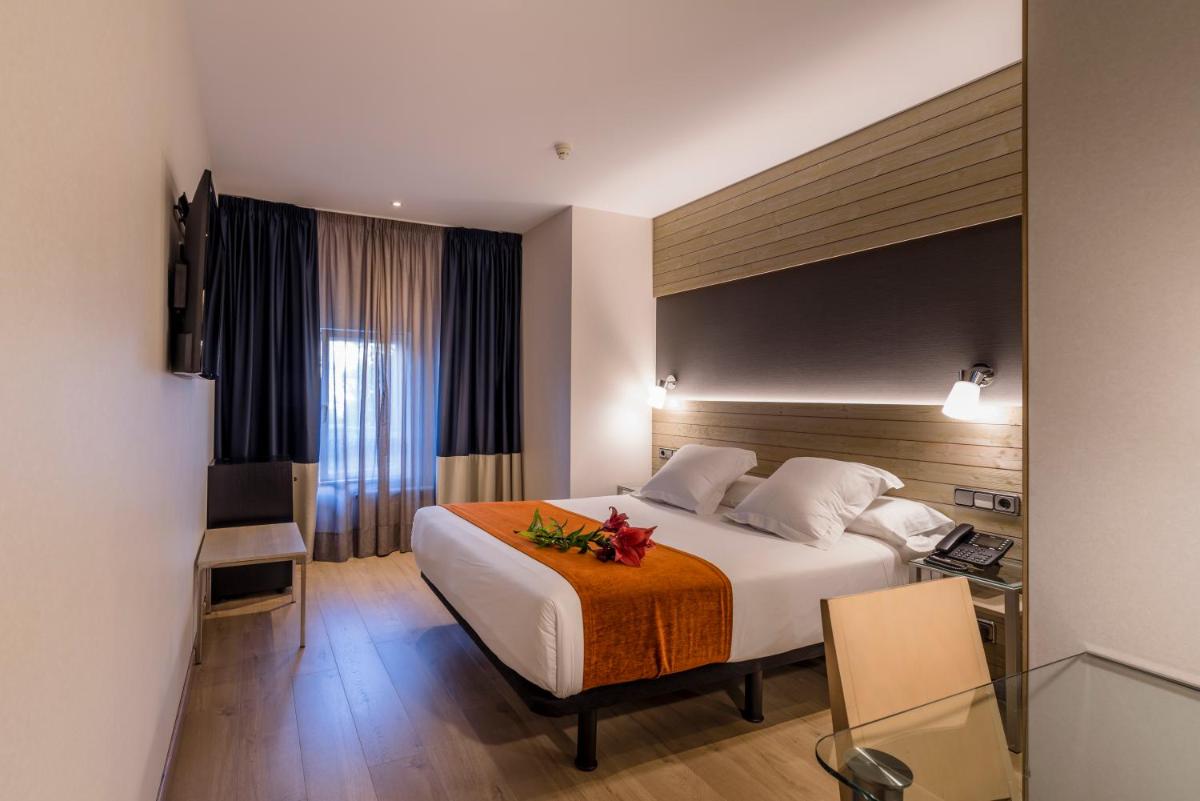 Cama o camas de una habitación en Hotel Avenida