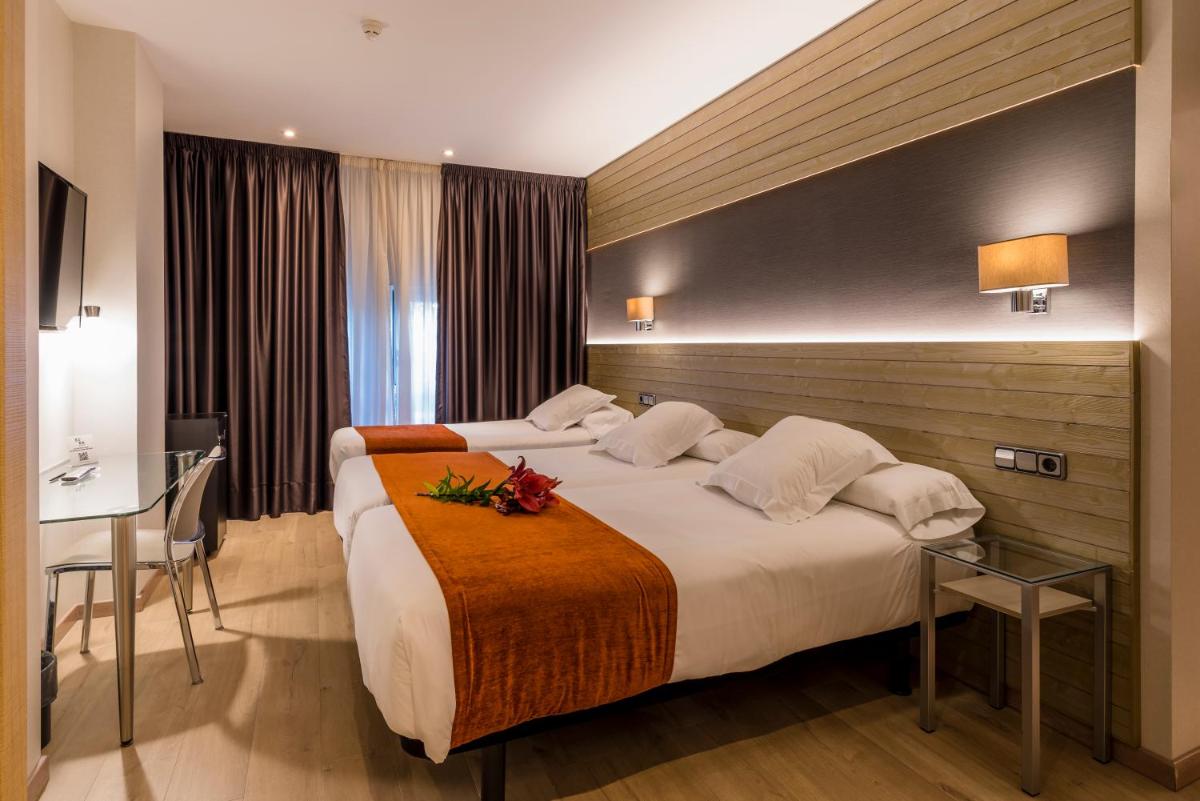 Cama o camas de una habitación en Hotel Avenida
