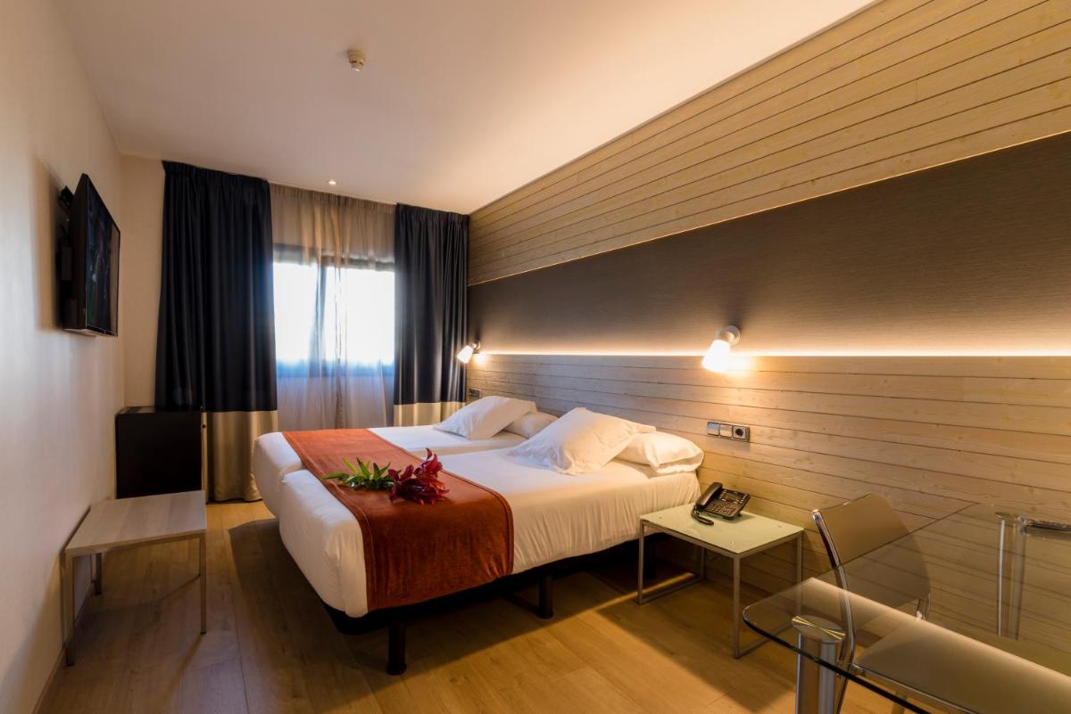 Cama o camas de una habitación en Hotel Avenida