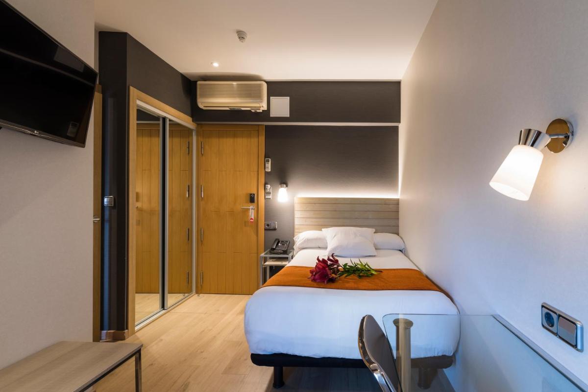 Cama o camas de una habitación en Hotel Avenida